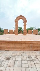 This photos showcase the iconic sandstone arch at Aksharbhoomi, a cultural and artistic landmark located in Bhubaneswar, Odisha, India. 