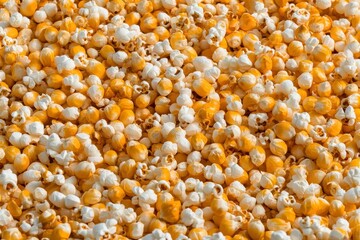 Close-Up View of a Colorful Mixture of Popcorn Kernels and Popped Pieces on a Light Background Perfect for Food and Snack Imagery