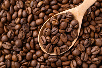 Roasted coffee beans with wooden spoon, Arabica coffee