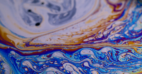 Blur psychedelic fluid. Paint flow. Defocused multicolor purple green liquid rainbow curve acrylic slick on dark black light abstract light art background.