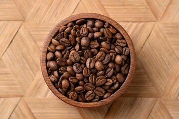 Roasted coffee beans in wooden bowl, Arabica coffee, Top view