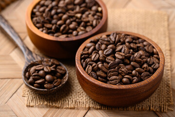 Roasted coffee beans in wooden bowl with spoon, Arabica coffee