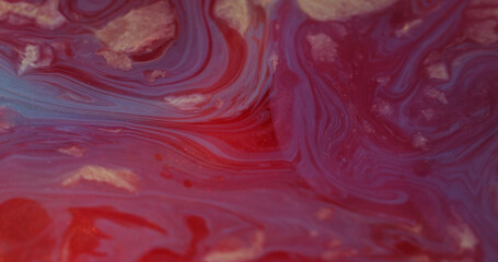 Defocused liquid. Spill marble texture. Colorful shimmering red gleaming paint flow bright...