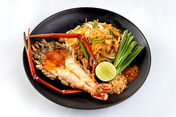 Pad Thai with glass noodles and grilled giant river prawns on a white background