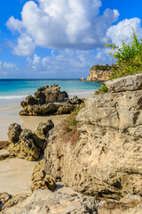 A rocky beach with a large rock in the foreground