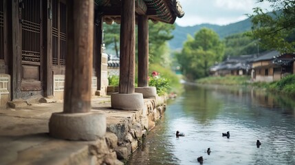 Charming traditional Korean Hanok building nestled by a calm serene stream with wooden pillars tiled roof and open sky copy space for text overlay