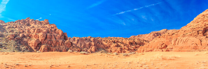 A desert landscape with a blue sky in the background