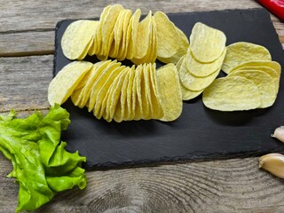 crispy potato chips on a sliced board