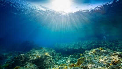 Tranquil underwater scene with sunlight rays piercing the deep blue ocean