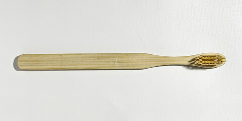 Eco-friendly dental health wooden toothbrush on a white background. Close up view in the studio.