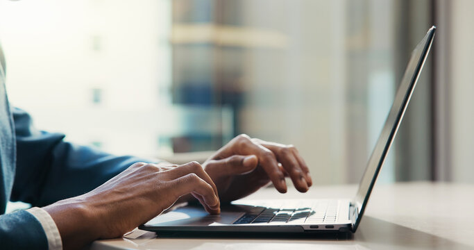 Man, hands and typing on laptop for business, economy research and stock exchange in office. Trader, scroll and tech in agency on cryptocurrency platform, market review and networking for information
