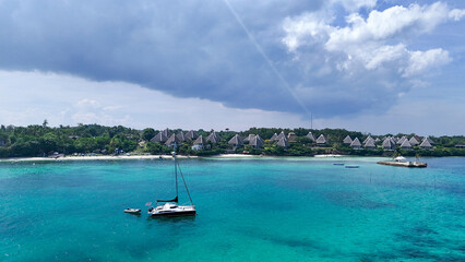 Luxury Beachfront Resort with Turquoise Waters and a Yacht