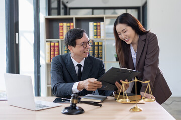 Fototapeta premium Lawyer or judge consult, Lawyers discussing about contract and agreement concept.