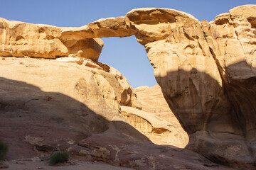 Jordan, Wadi Rum desert. Stone bridge. Incredible landscapes with vibrant colors on all sides. Martian city surrounded by incredible rocks and mountains of bizarre shapes..
