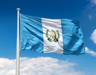 Guatemala flag waving in the wind against a blue sky background