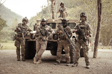 United States Army in camouflage uniforms operation in the forest.with armored vehicle, soldiers training  in a military operation