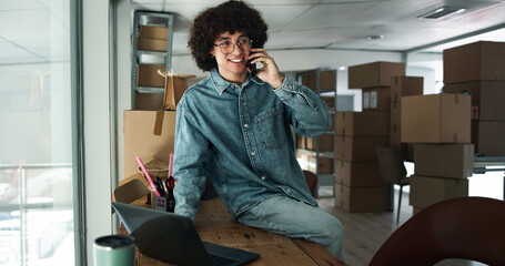 Phone call, delivery and man on laptop with boxes for shipping, online orders and ecommerce. Business, startup and person talking for client package, distribution or supply chain logistics in factory