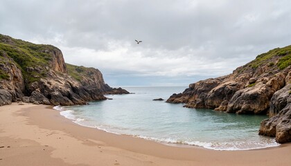 Quiet  beach cove with rocky cliffs and overcast sky
