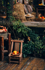 An old-fashioned wooden chair with fruit placed in one corner of the wooden house