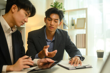 Professional lawyer in formalwear discussing contract terms with client during at office