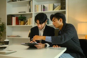 Lawyer in formal suit pointing at paper and explaining contract details to client
