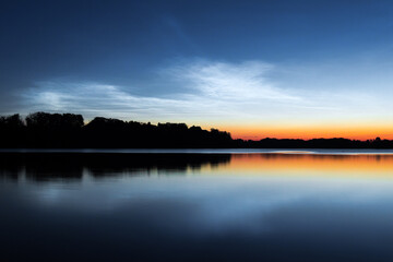 noctilucent clouds, nlc, July, silvery clouds appearing above the lake surface