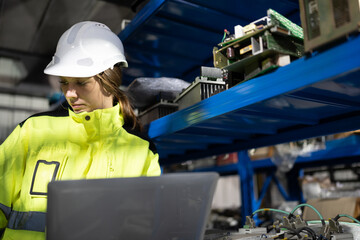 Caucasian engineer or technician woman use notebook computer checking stock