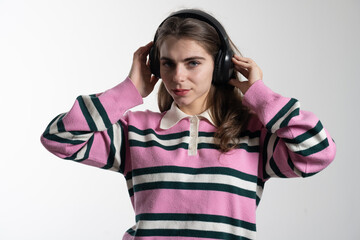 Young girl listening to music with headphones and dancing