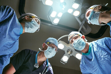 Hospital, teamwork and low angle of doctors in surgery for emergency crisis, medical service and...