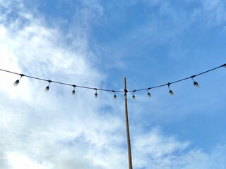 Light bulb with cloud in blue sky