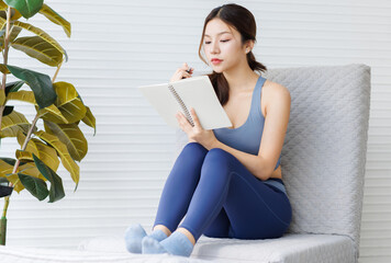 Asian young beautiful cheerful woman, active sport girl in exercise sportswear sitting relax on...