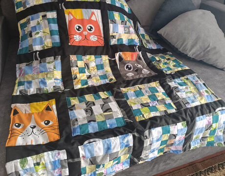 Bright baby quilt made of colorful patchwork 