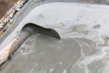 A concrete mixer is being used to mix concrete