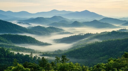 Obraz premium Serene mountain landscape with misty valleys at dawn.