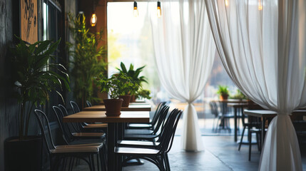 "Empty coffee shop interior design featuring black steel chairs and tables, clear glass decorations, white curtains, and plant pots."