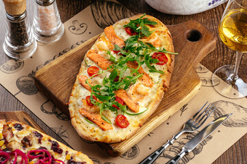 pizza with seafood sauce, mozzarella cheese and arugula