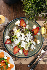 seafood salad with sesame seeds and a glass of wine