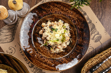 Baked potato dumplings with mushrooms and parmesan cheese