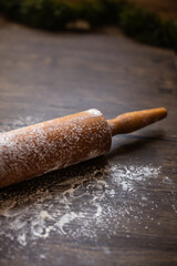 close-up of a rolling pin with flour on it on wood with copy space
