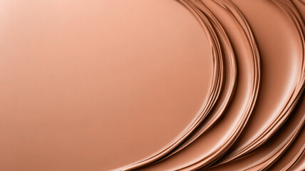 Close-up of stacked, curved, peach-colored surfaces with textured finish