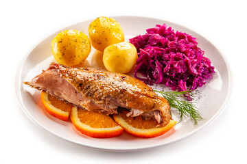 Roast duck breast with boiled potatoes and pickled red cabbage on white background