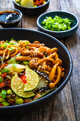 Asian style stir fried vegetables and noodles on wooden table