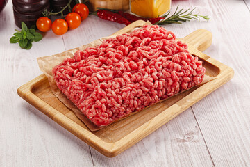Raw minced beef meat over board