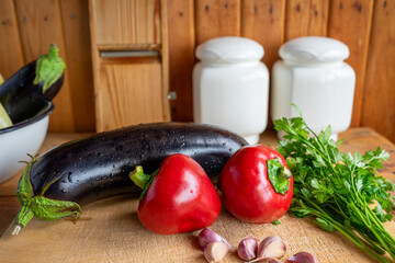 Fresh vegetables arranged on a wooden cutting board in a rustic kitchen