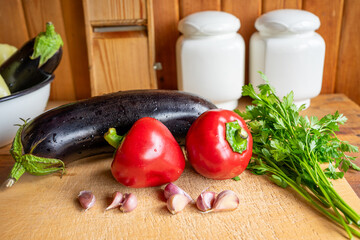 Fresh vegetables and herbs on a wooden cutting board in a rustic kitchen