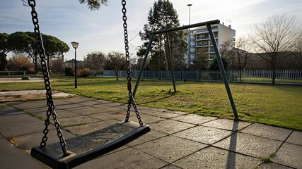 Tranquil park swing movement on sunny day