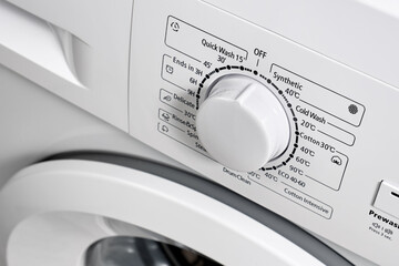 Close-up of the control panel of a modern washing machine white color. Circle selector for choosing...