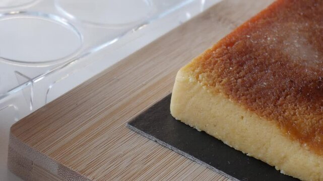 Panning sweet Turron Yema nougat with eggs on a wooden board evokes a homey mood