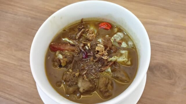Traditional homemade mutton curry from Indonesian, Asian cuisine. Delicious and spicy beef curry. A bowl of mutton with abundant spices.
