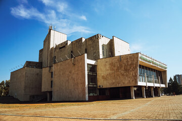 The Irkutsk musical theater shows unique modern architecture with distinct geometric shapes against a bright sky.